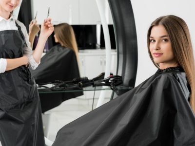 young woman with hair stylist in beauty salon young woman with hair stylist in beauty salon